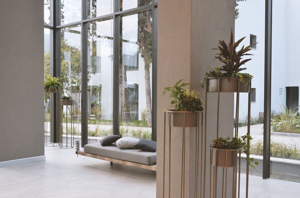 A modern interior with a seating area, large windows, and potted plants. - Paloma Finesse All Inclusive (Manavgat)