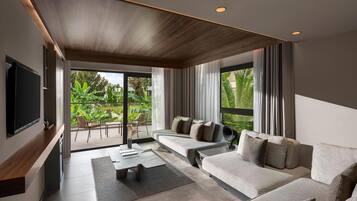A modern living room with a sofa, a coffee table, and a TV mounted on the wall.