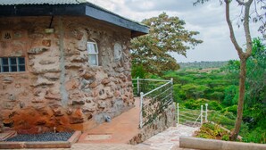 A stone building with a window and a metal railing. - Leleshwa Getaway (Nairobi)