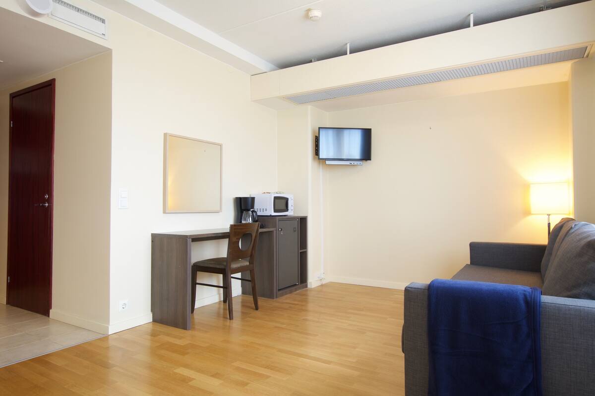 superior triple room, 1 queen bed with sofa bed, non smoking | living room | 42-inch led tv with cable channels, tv