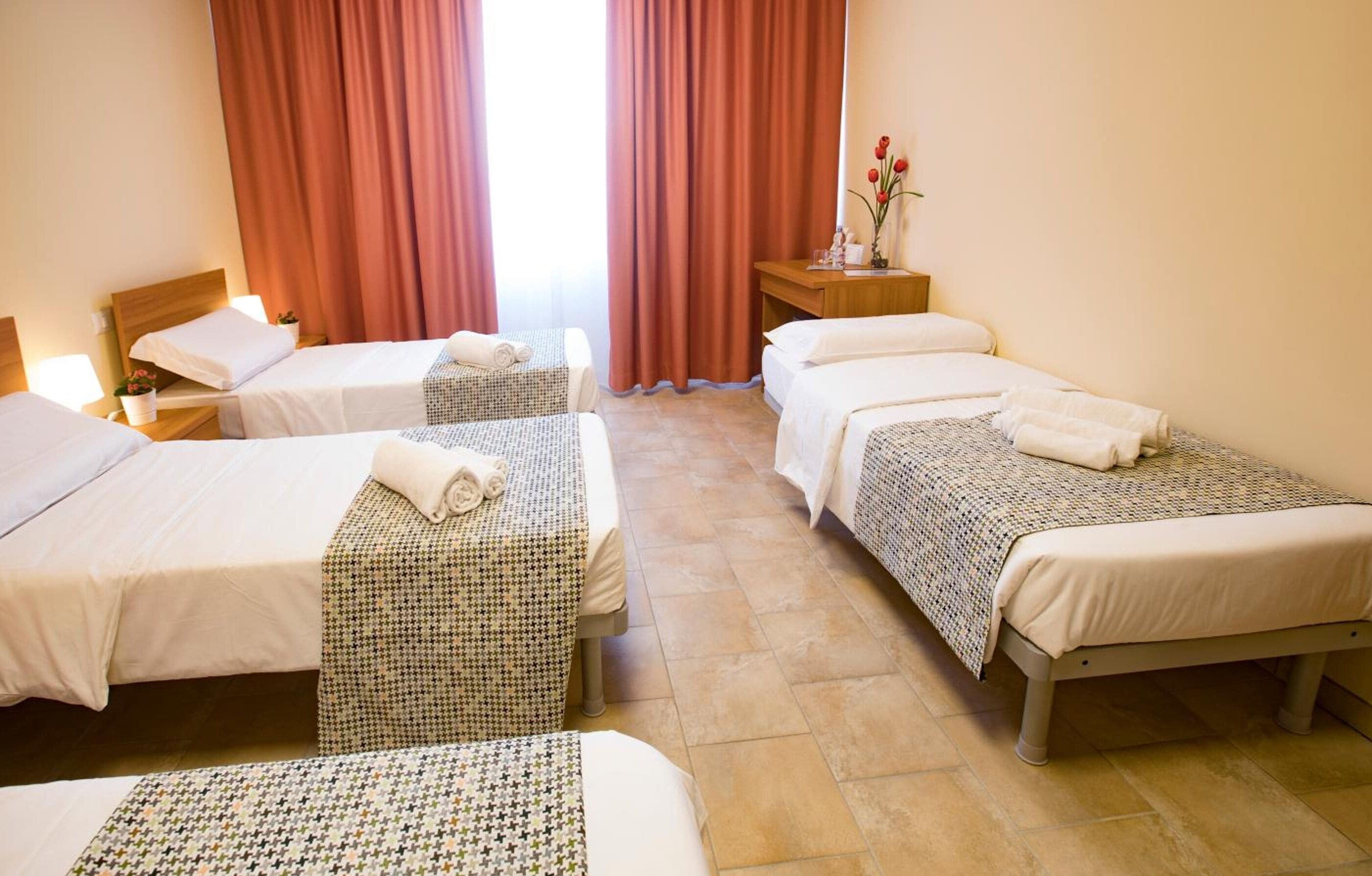 Quadruple Room | Down comforters, desk, blackout drapes, iron/ironing board