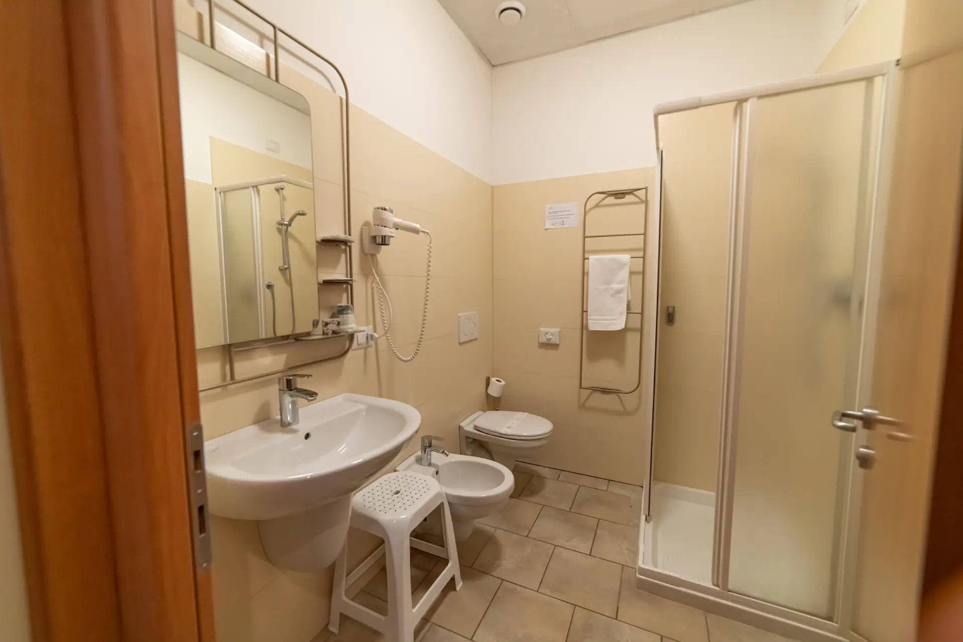 A bathroom with a sink, toilet, and shower.