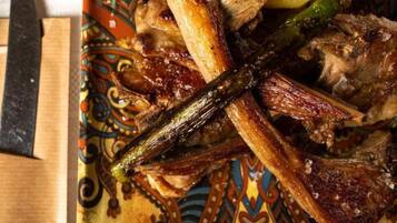 A plate with roasted meat, potatoes, and asparagus.