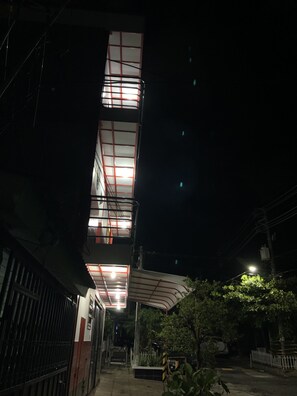 A multi-story building with a central staircase and a covered outdoor area. - Casa Hotel la Casa Vieja (San Salvador)