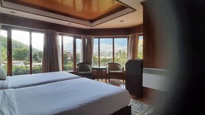 A hotel room with two beds, a television, a small table, and a chair. - Kisa Villa (Thimphu)
