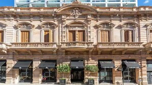 A historic building with ornate architectural details, multiple storefronts, and a prominent entrance.