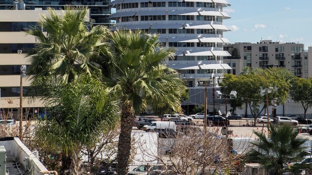 A modern building with a spire, a flag, and a sign indicating 'Capitol Records.' - The Hotel Hollywood (Los Angeles)