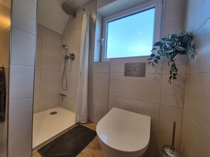 Shower, hair dryer, towels, toilet paper