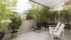 A balcony with potted plants and white chairs. - CdC Apartments By Casa do Conto (Porto)