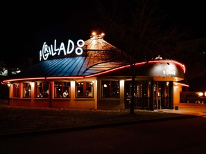A restaurant with a distinctive sign and a curved roof.