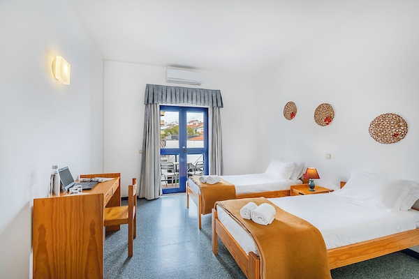 Twin Room, Shared Bathroom | Blackout drapes, WiFi (free), bed sheets