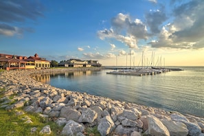 Waterfront accommodations with a traditional architectural style, offering access to a dock and sailboats.