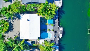 An aerial view of a resort with a pool, lounge area, and palm trees. - Best Location for Your best vacation!  (Islamorada, Village of Islands)