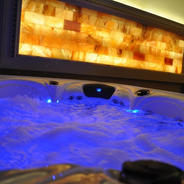 A hot tub with a digital control panel and a wooden panel above it. - Elite Palace (Tirane)