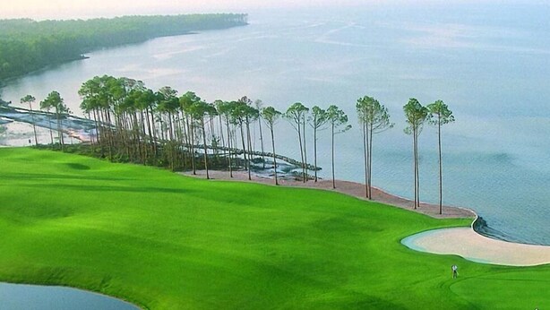 A golf course with a water body, sand bunkers, and a bridge. - Crystal Vista with Private Pool, Gulf Views, and Beach Chair Setup (Destin)