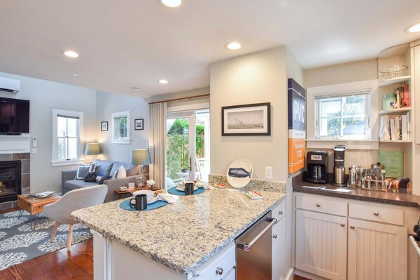 A modern kitchen with granite countertops, a built-in oven, and a coffee maker. - 4 min Walk to Commercial Street and Beach! (Provincetown)