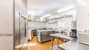 A modern kitchen with stainless steel appliances, a coffee maker, and a tiled backsplash. - Alval House for 23 people (Villacastín)