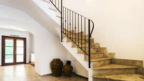 A staircase with a black metal railing leading to a landing. There are two large vases on the landing. - Ca na Patrona, viewpoint to Capdepera Castle. With pool and bbq (ETV / 8903) (Capdepera)