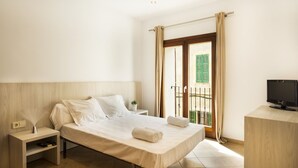 A hotel room with a bed, bedside table, TV, and a balcony with a view. - Ca na Patrona, viewpoint to Capdepera Castle. With pool and bbq (ETV / 8903) (Capdepera)