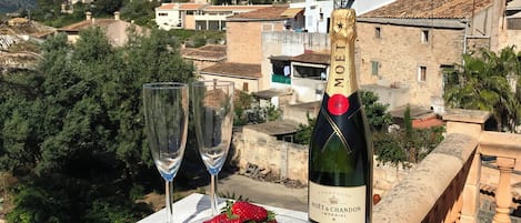 A table with a bottle of Moët & Chandon Imperial champagne, two glasses, and a bowl of strawberries.