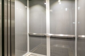 A modern elevator with a metallic handrail and a glass panel. - Vail Mtn Views and Rooftop Hot Tub LH314 (Vail)