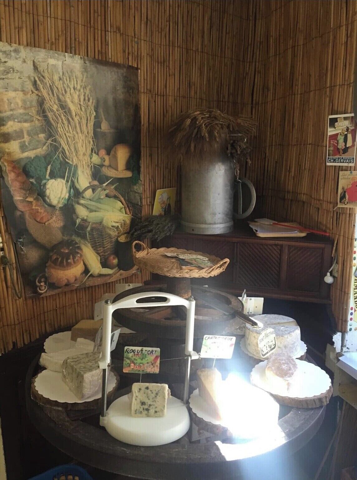 A cheese display with various types of cheese and a rustic wooden interior.