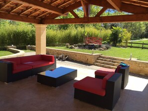 Relax on the patio with a wicker sofa set and enjoy the serene surroundings.