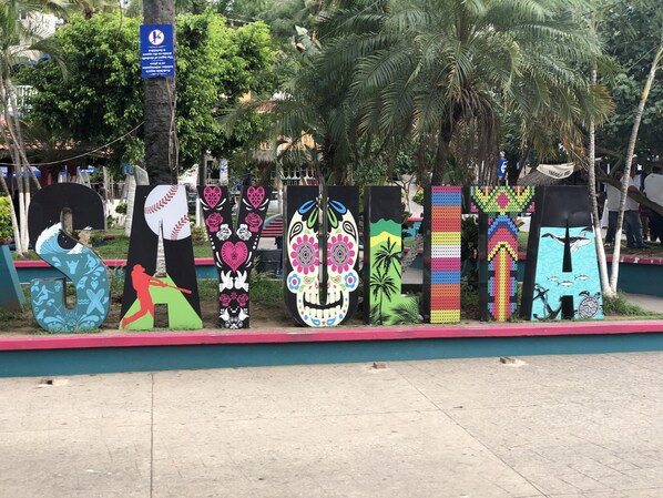 A row of colorful, uniquely designed letters on a sidewalk.