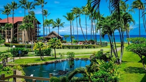 A resort with a pool, palm trees, and a view of the ocean. - GORGEOUS OCEANFRONT PENTHOUSE  (Lahaina)