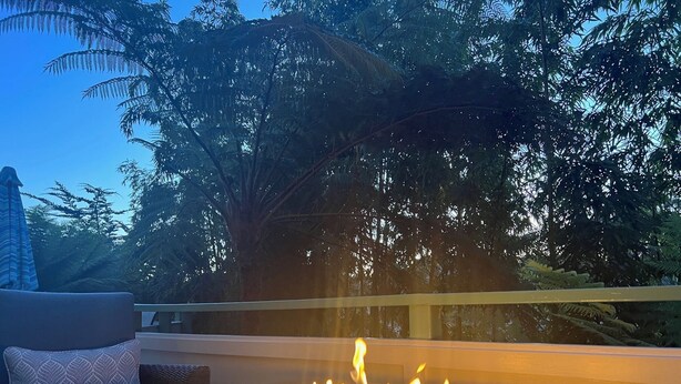 A fire feature in a modern outdoor seating area with a view of trees and a clear sky. - Rio Del Mar Aptos-two blocks to the Sand, Ocean, Store, Restaurant, Coffee shop (Aptos)