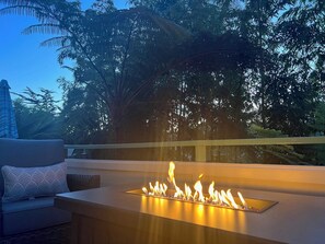 A fire feature in a modern outdoor seating area with a view of trees and a clear sky. - Rio Del Mar Aptos-two blocks to the Sand, Ocean, Store, Restaurant, Coffee shop (Aptos)