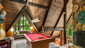 A cozy room with a pool table, a sofa, and a fireplace. - Honey Bear– Unique A-Frame Chalet w/ Mt LeConte View & Hot Tub in Gatlinburg (Gatlinburg)