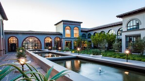 A courtyard with a central water feature, arched windows, and potted plants. - Sante Wellness Retreat & Spa (Paarl)