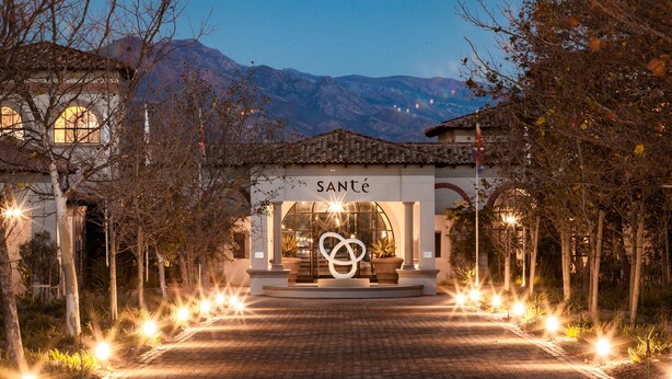 A hotel entrance with a sign reading "SANTÉ" and a decorative infinity symbol in the center. - Sante Wellness Retreat & Spa (Paarl)