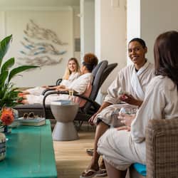 Relax in a calm and inviting space with comfortable seating and a contemporary art piece.