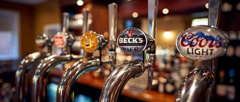A row of beer taps with labels including Beck's, Coors Light, and others.