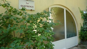 A building with a sign reading "La Quatrenco" and a large arched window. - Villa with private pool, views of the Ventoux (Saint Paul trois Chateaux)