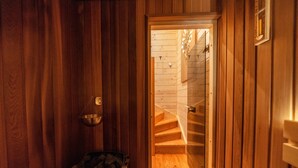A wooden interior with a wooden staircase leading to a second floor. - Domki Ze Hej z kominkiem lub sauną (Zakopane)