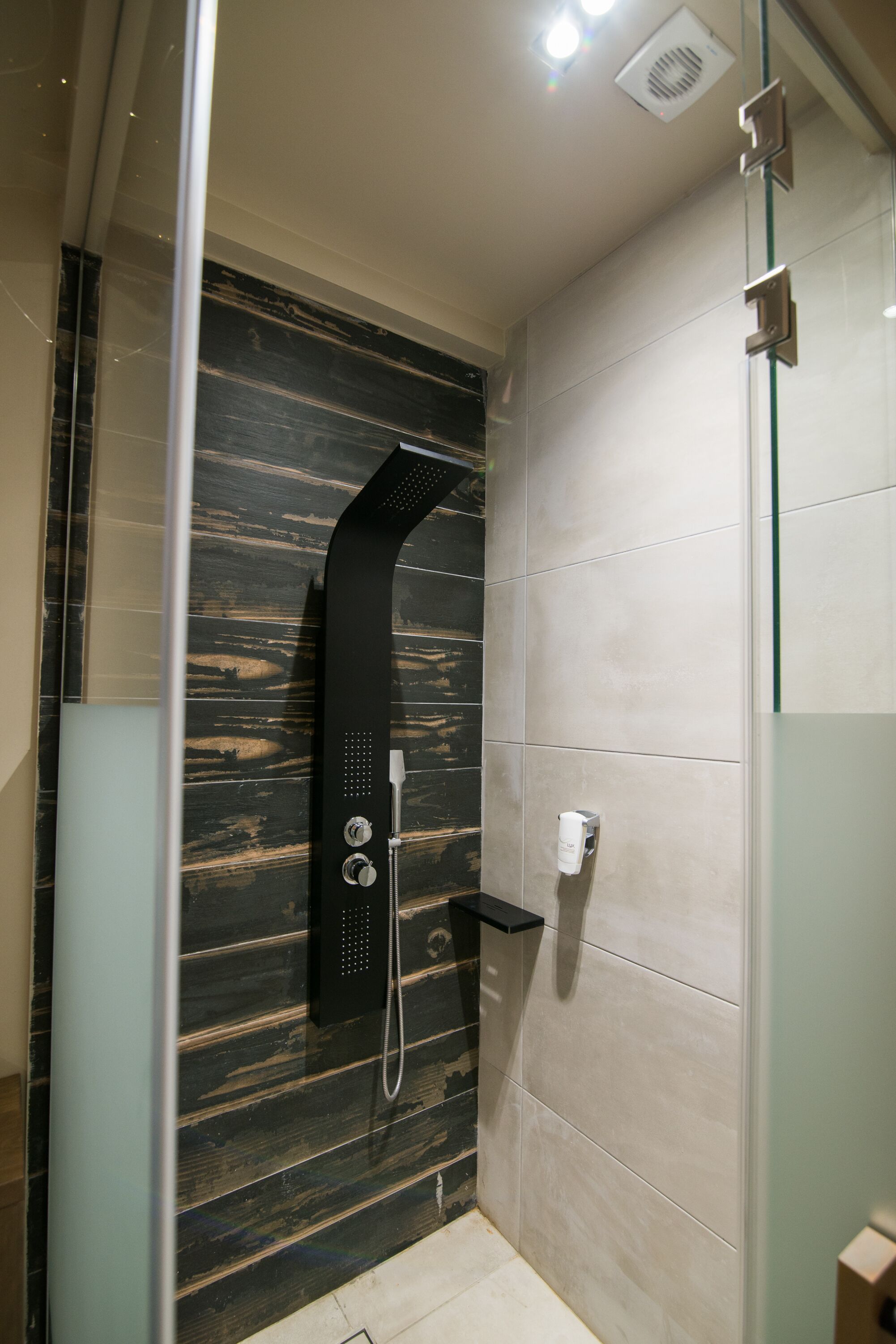 signature suite | bathroom | shower, free toiletries, hair dryer, slippers