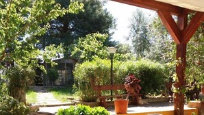An outdoor patio with a table and chairs, surrounded by potted plants and a stone floor. - VIILLA PAOLA 4 beds, private garden in the Residence Villa Carla (Vieste)