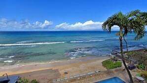 A beach view with a pool and lounge chairs. - Corner condo with direct beach access (Lahaina)
