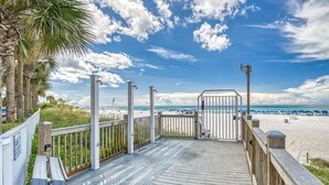 A wooden boardwalk leading to a beach with palm trees and a clear sky. - Gulf Front Beauty - Beach Service for 2- Owner Managed (Panama City Beach)