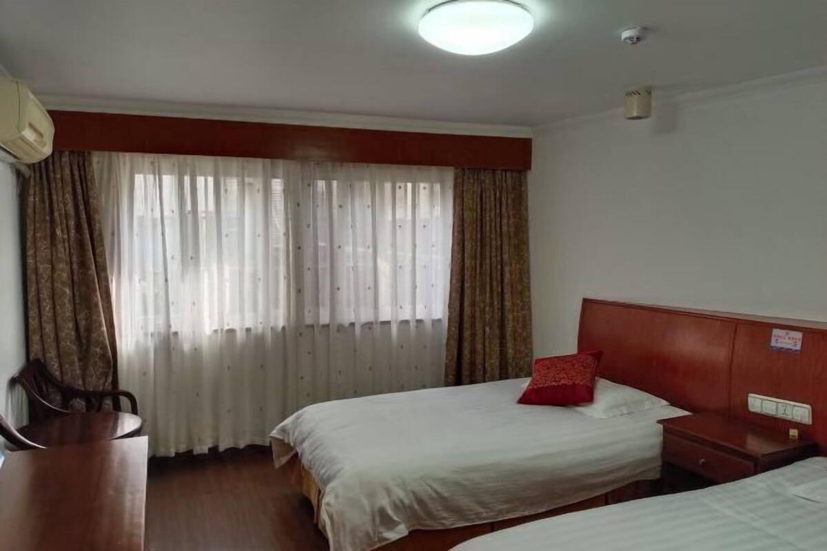 Una habitación de hotel con dos camas, un escritorio y una silla.
