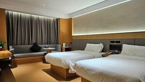 Une chambre d’hôtel moderne avec deux lits simples, un canapé, une petite table et une grande fenêtre avec des rideaux.