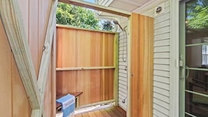 A wooden deck with a bench and a towel labeled 'DELAMAR.' - Minutes to Nauset Beach, Central AC, Game Space! (Orleans)