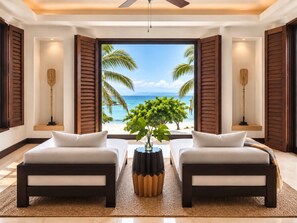 Habitación con dos camas, un ventanal con vista a la playa y un ventilador de techo.