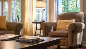 A cozy room with a large window, a lamp, and a chair. - Awesome Decorated Lovely, Spacious Townhome by Isabella Golf Course!   (Hot Springs Village)