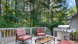 A deck with outdoor furniture, a grill, and a view of a forest. - Awesome Decorated Lovely, Spacious Townhome by Isabella Golf Course!   (Hot Springs Village)