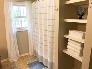 Combined shower/tub, hair dryer, towels, soap