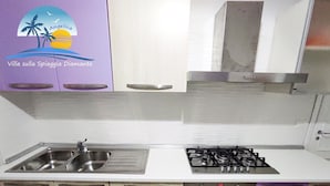 A compact kitchen with a sink, stove, and oven. - Villa on the Diamante beach  (Belvedere Marittimo)